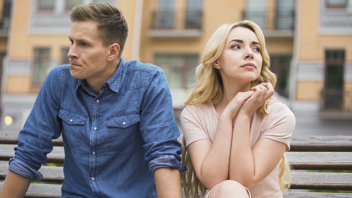 Man and woman breaking up on bench