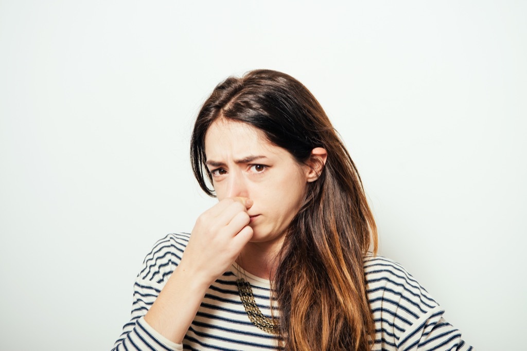 Woman Plugging Nose Over 40