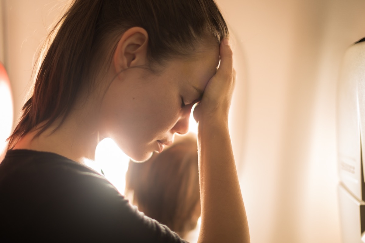 annoyed woman on airplane things that horrify flight attendants