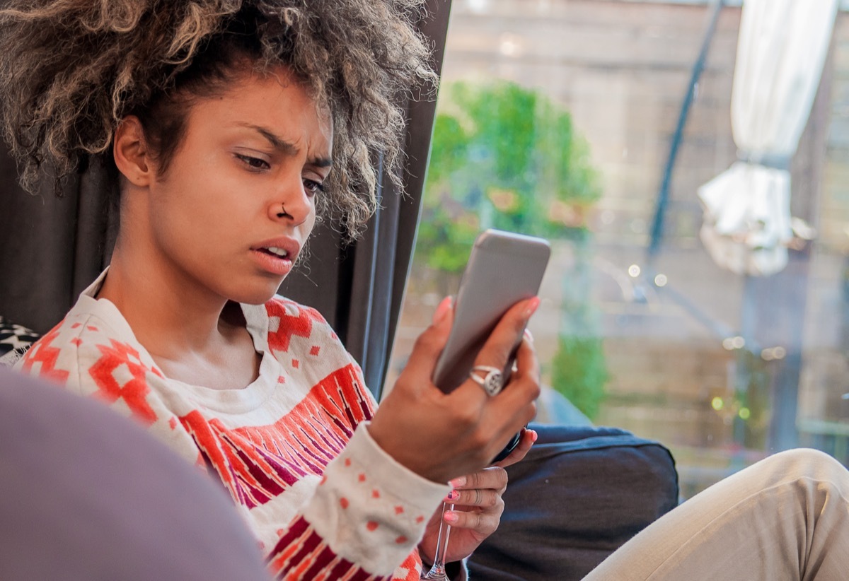 woman looking annoyed at phone