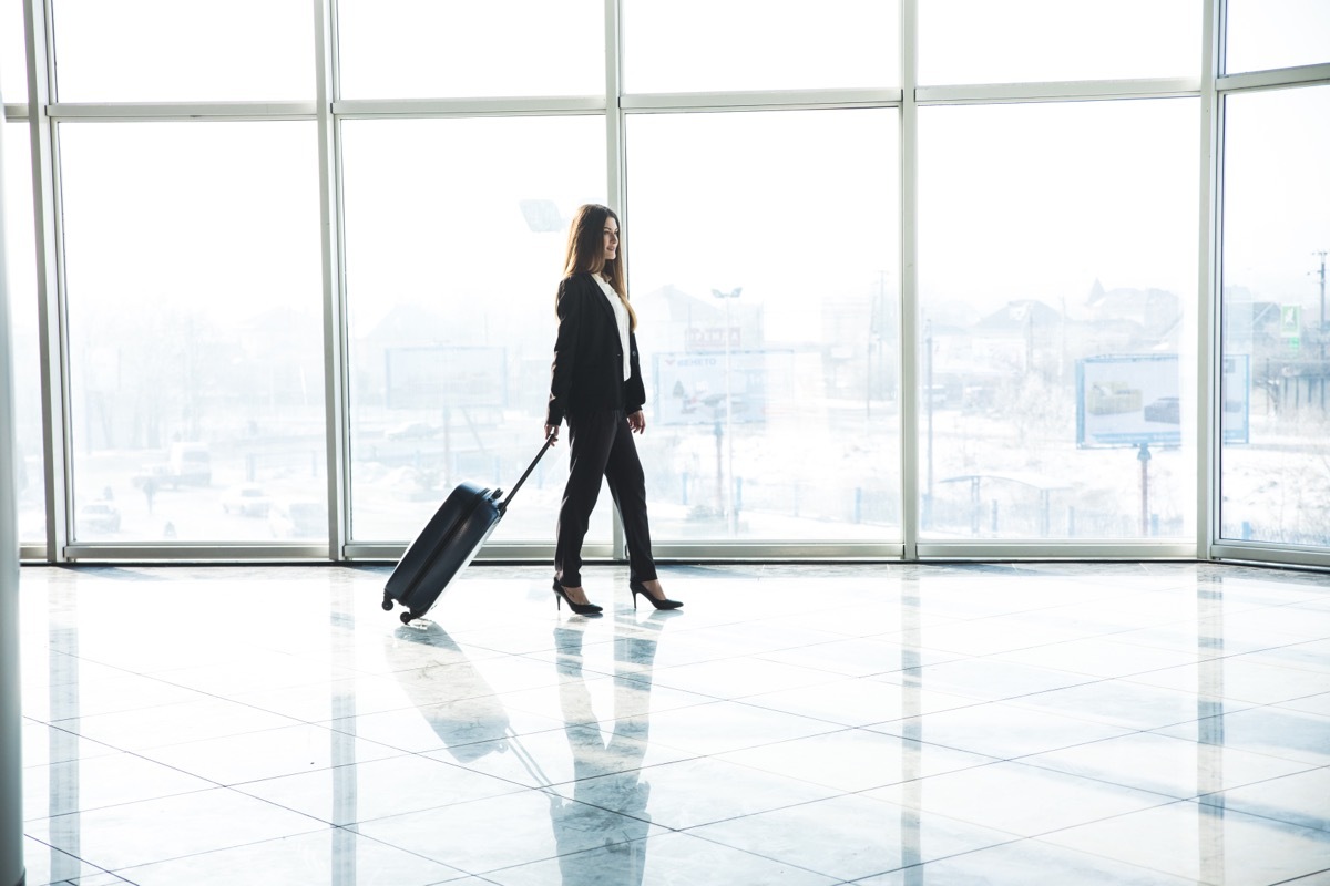 Business woman on a business trip in airport terminal