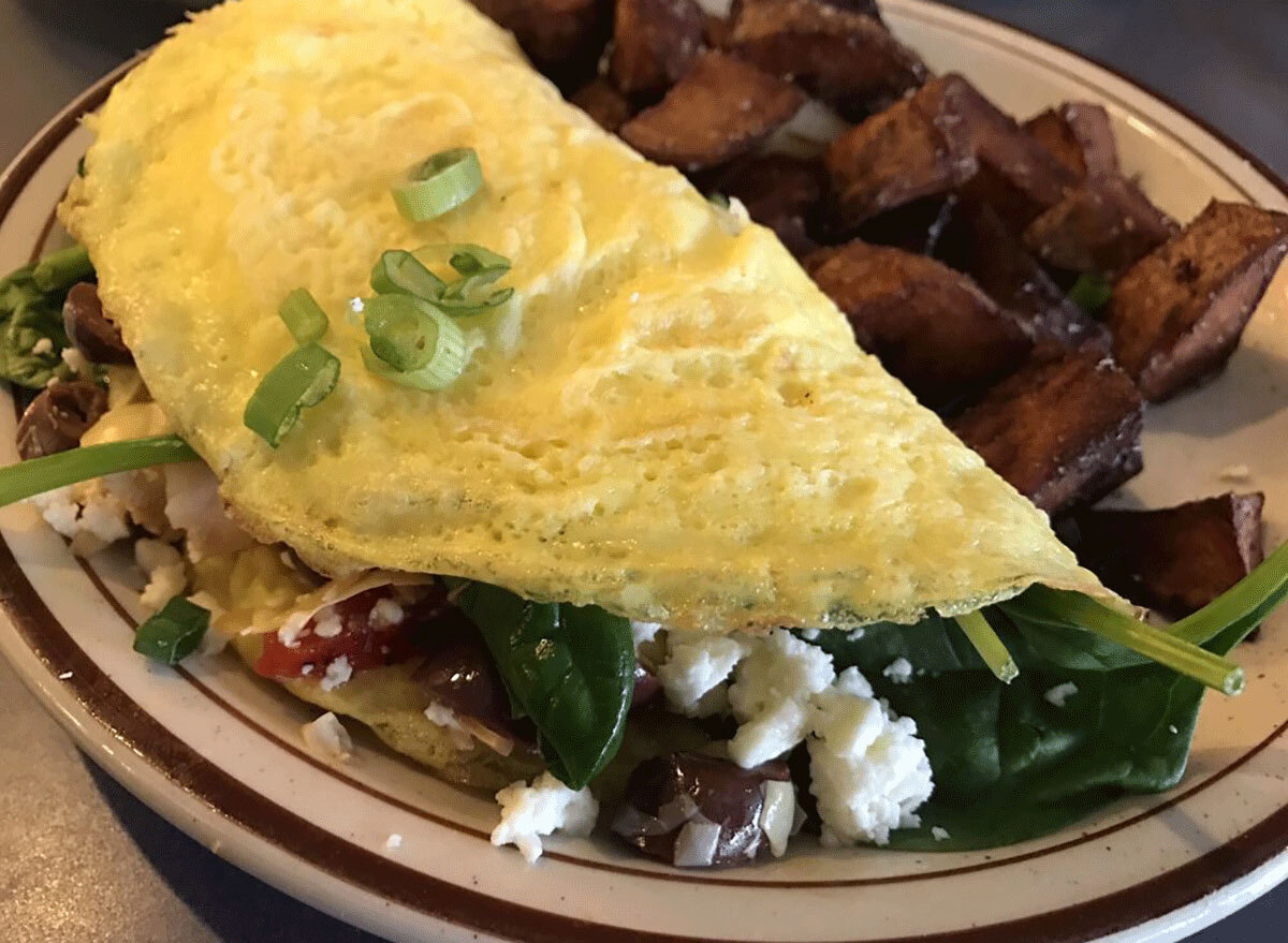 greek omelette with feta, spinach, olives and tomatoes with home fries on the side from southwest diner