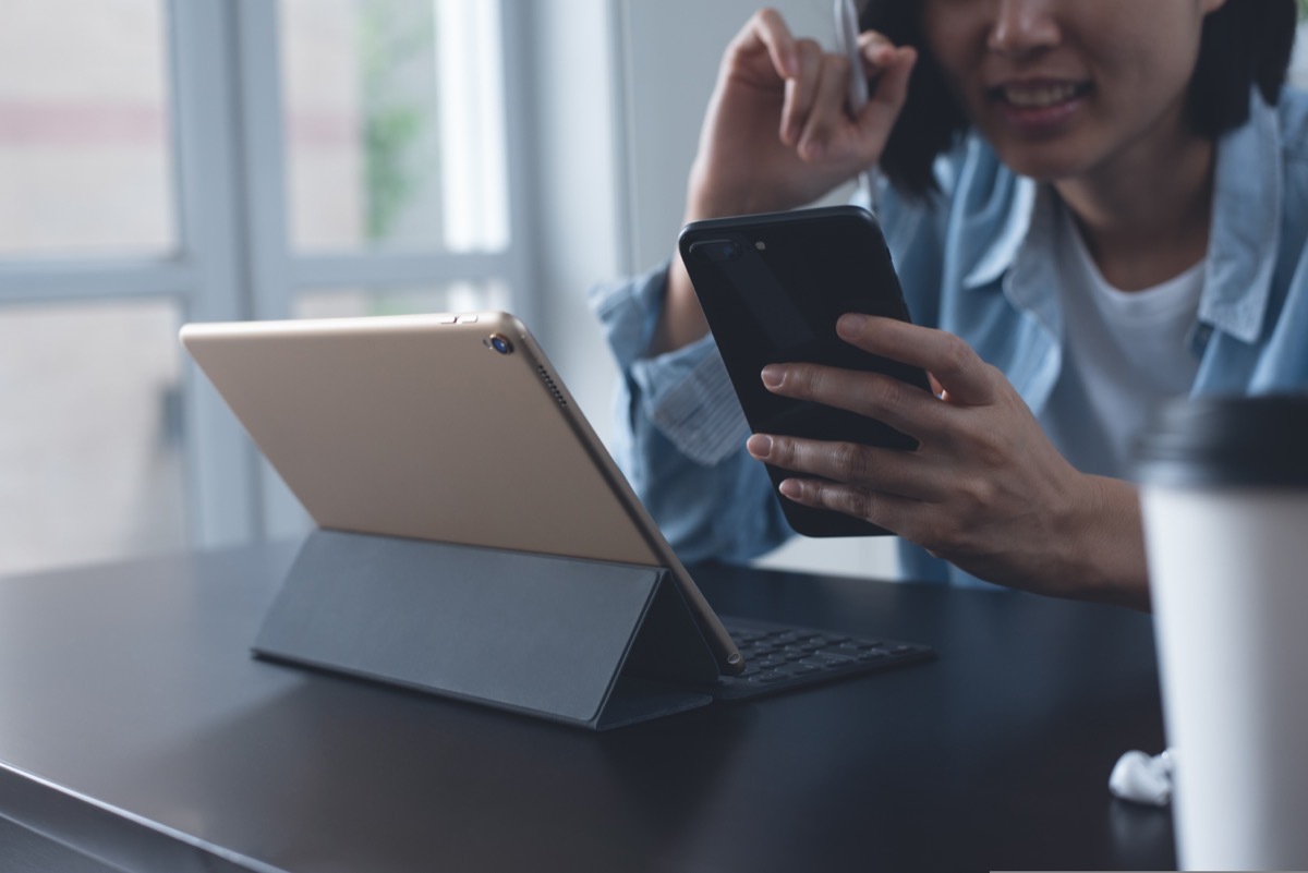 Woman on both ipad and phone