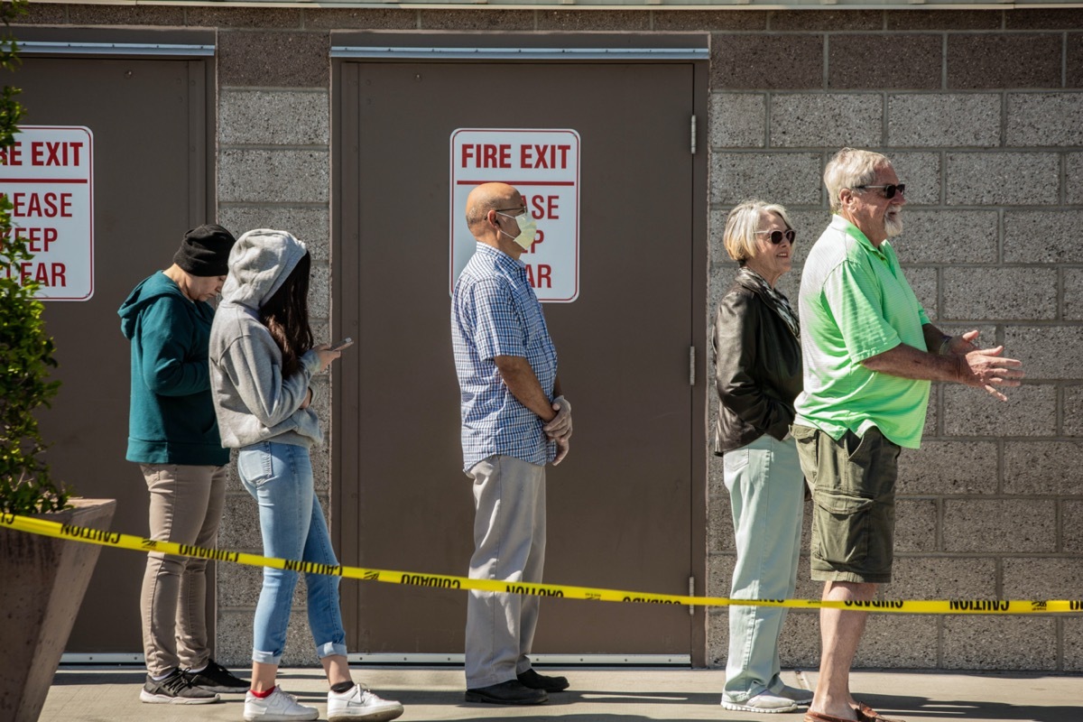 Shoppers practicing social distancing lined up outside retail warehouse store in Tucson during the coronavirus pandemic