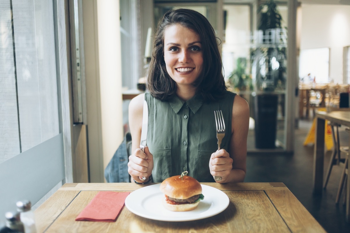 woman waiting to eat with knife and fork tomorrow