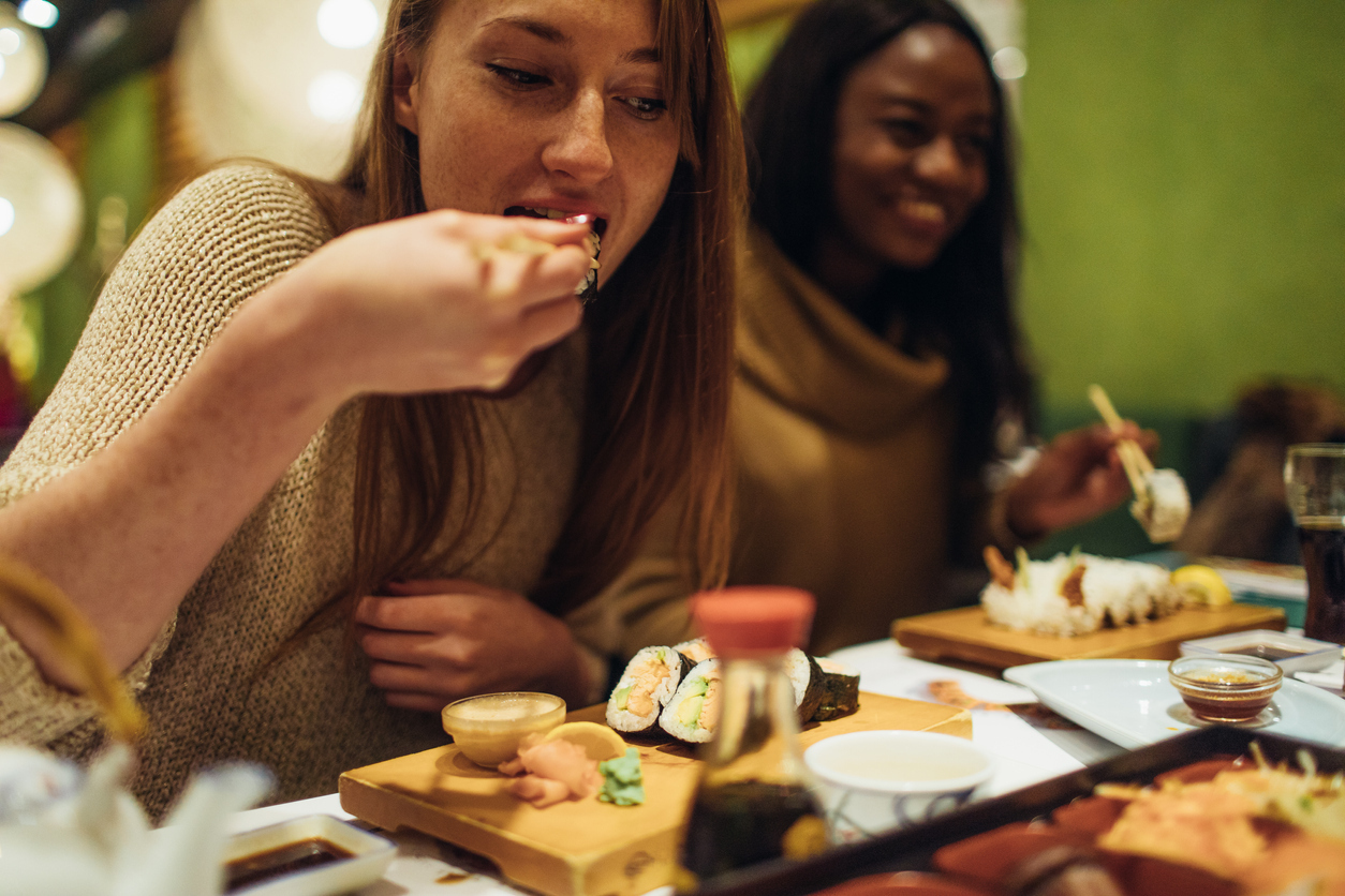 Multi-ethnic group of female friends who enjoy together in each other's company, during dinner in a Japanese restaurant