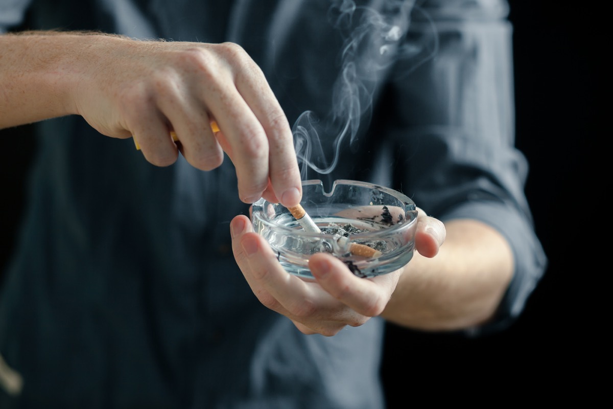 Man putting out a cigarette after smoking