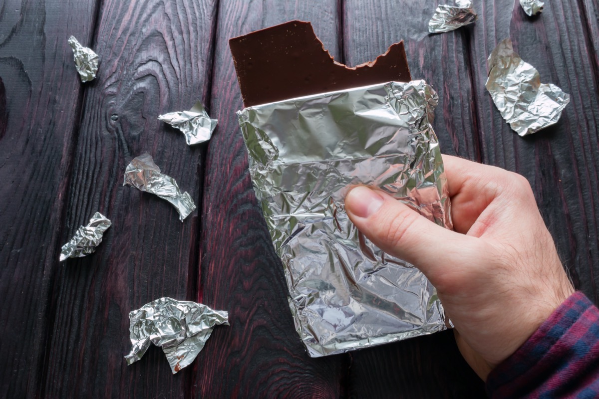 man eating a bar of chocolate