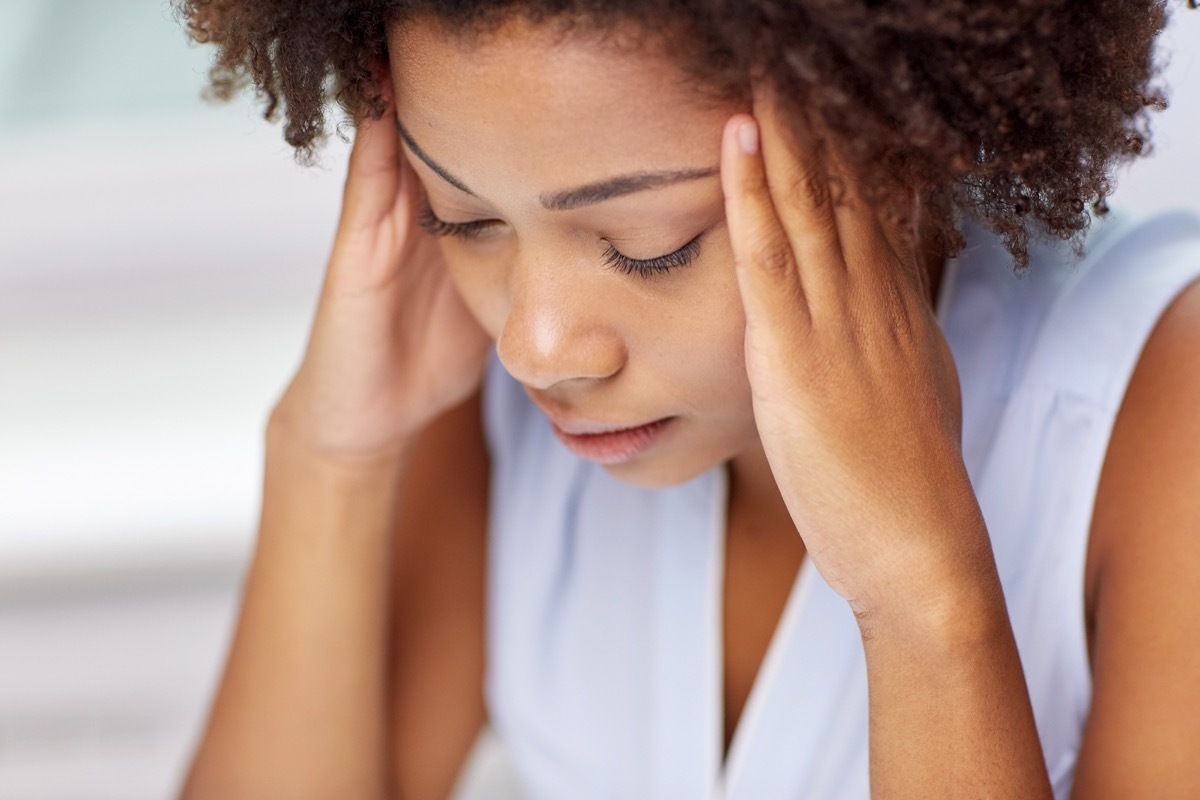 people, emotions, stress and health care concept - unhappy african american young woman touching her head and suffering from headache How Depression Affects the Body