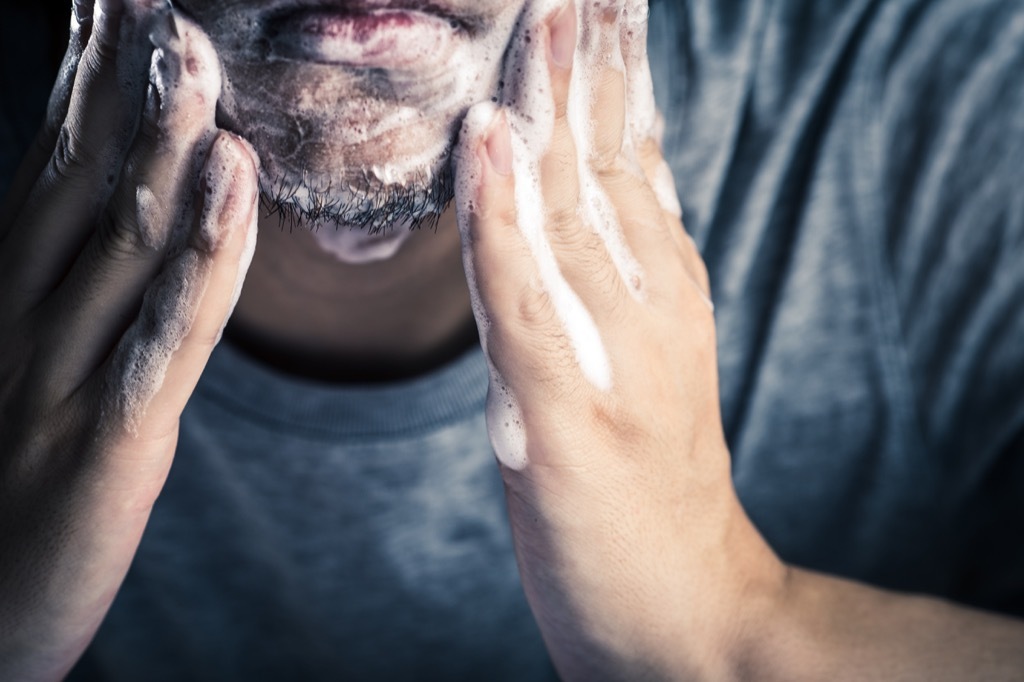 man washing his face