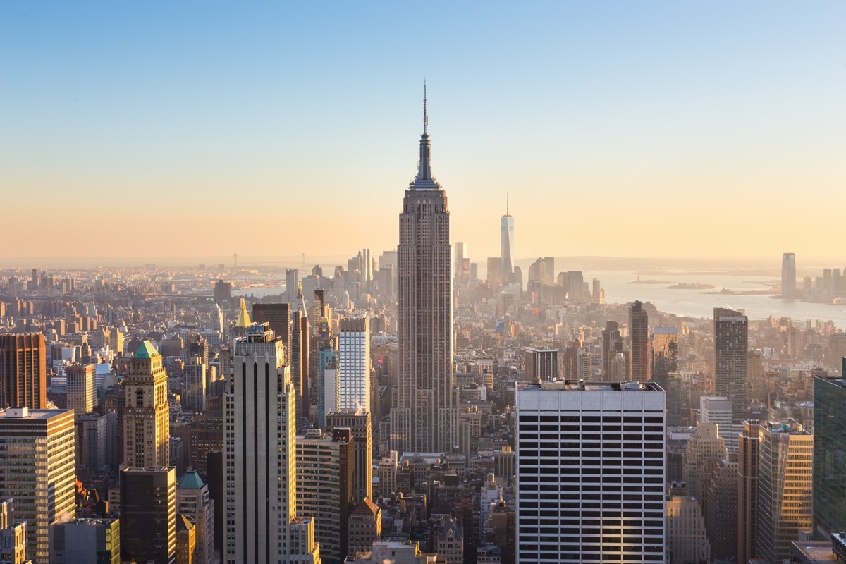 empire state building standing tall amongst skyscrapers in New York City