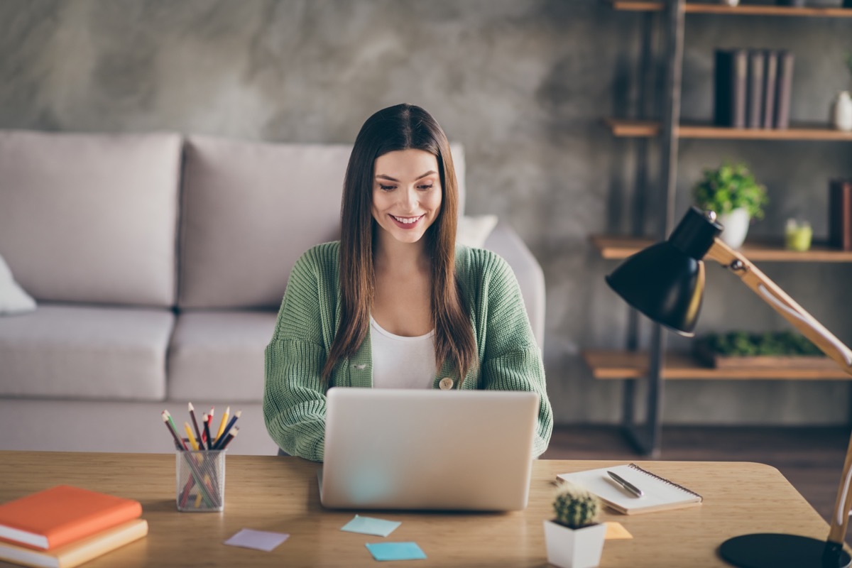 Woman wearing Light Green Sweater while Working