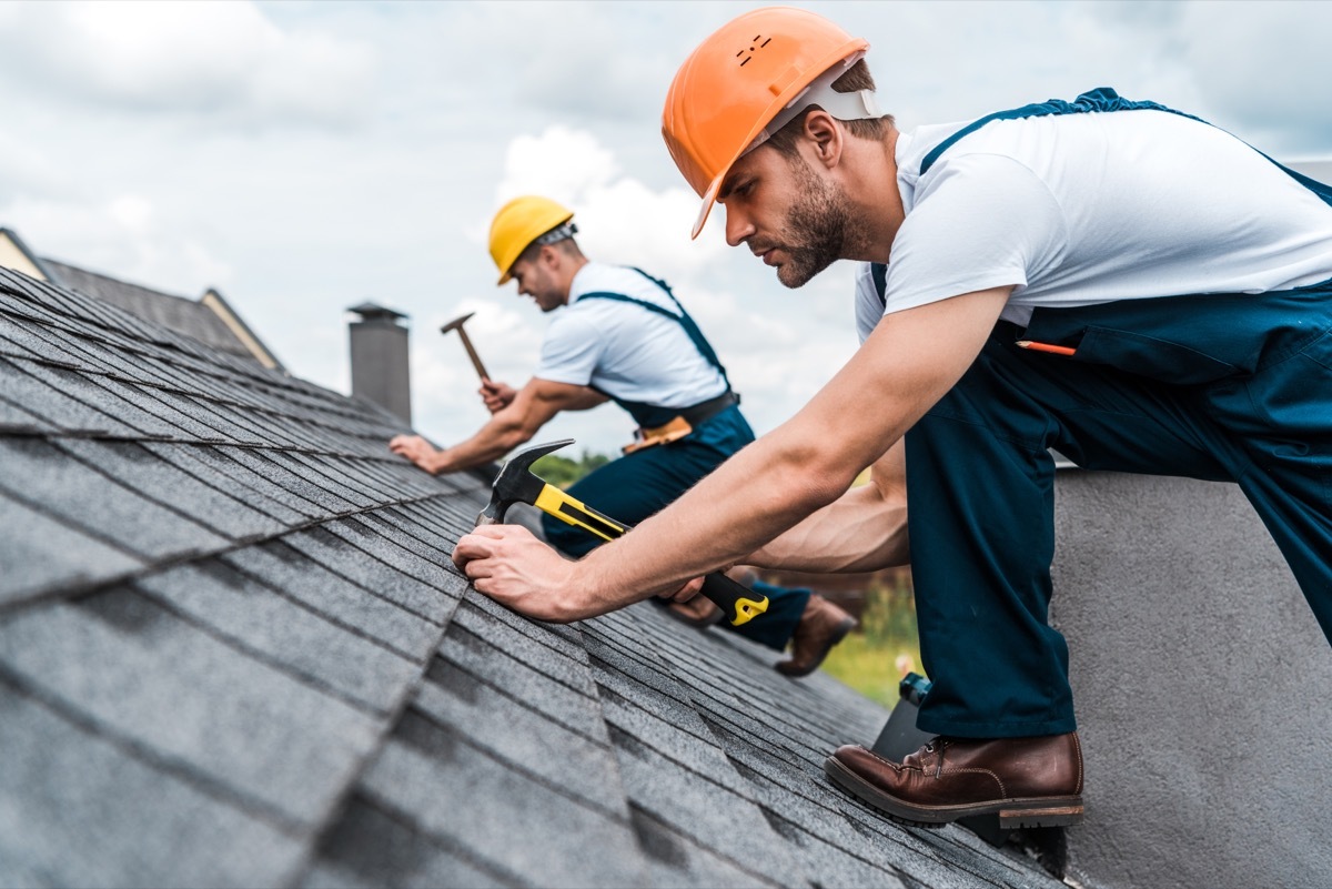 construction men repairing roof