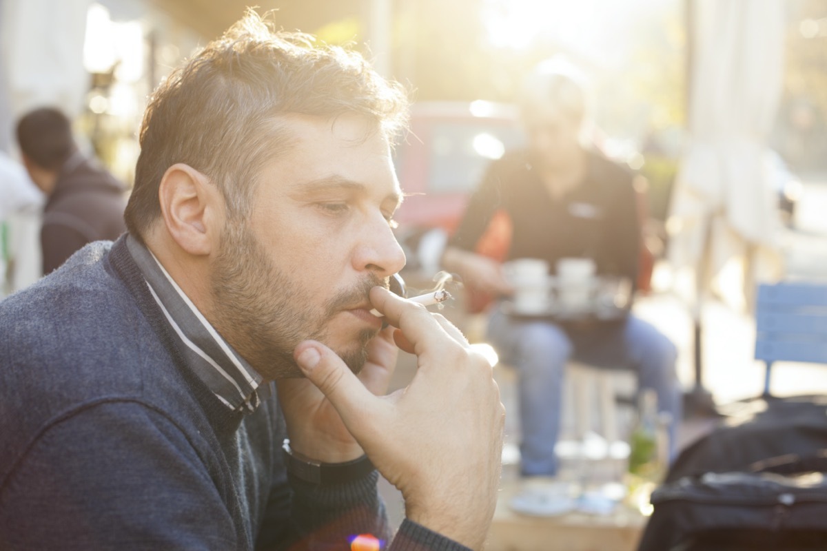 Man Smoking On Bright Sunny Day Outdoor