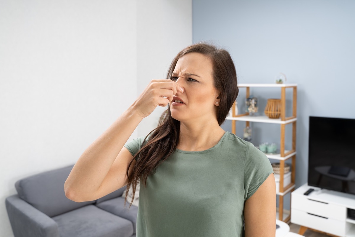 Woman Covering Her Nose From Bad Smell