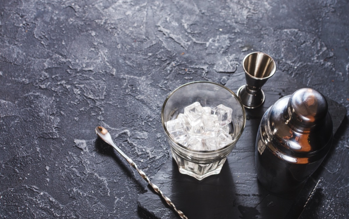 set of cocktail making tools on slate background