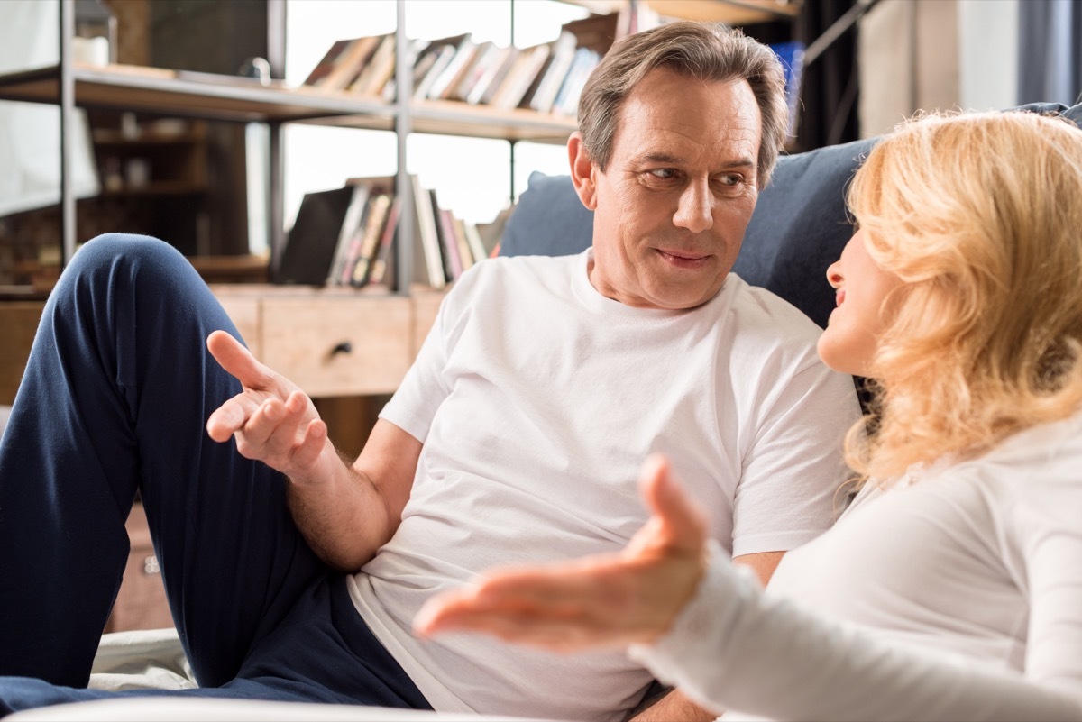 Older couple talking sitting on the floor