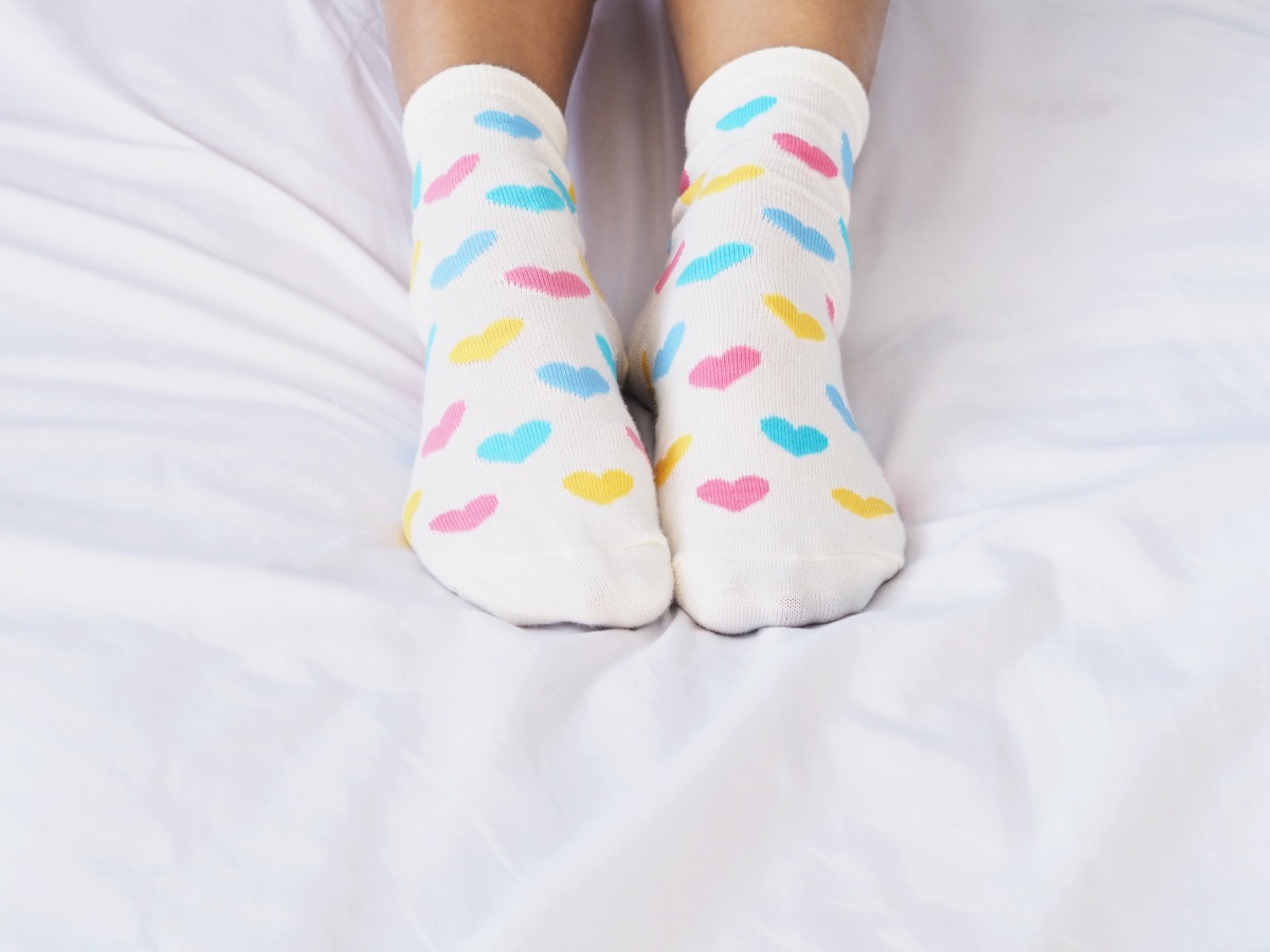 woman wearing socks in bed