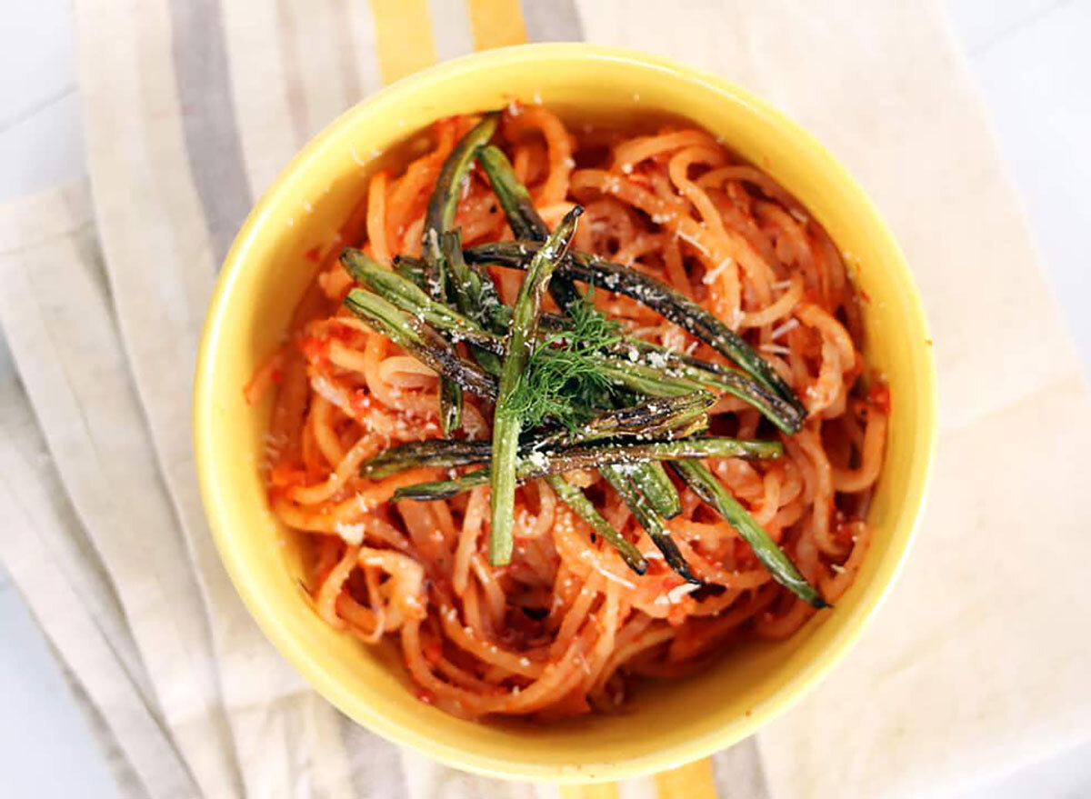 turnip noodles with tomato sauce in yellow bowl