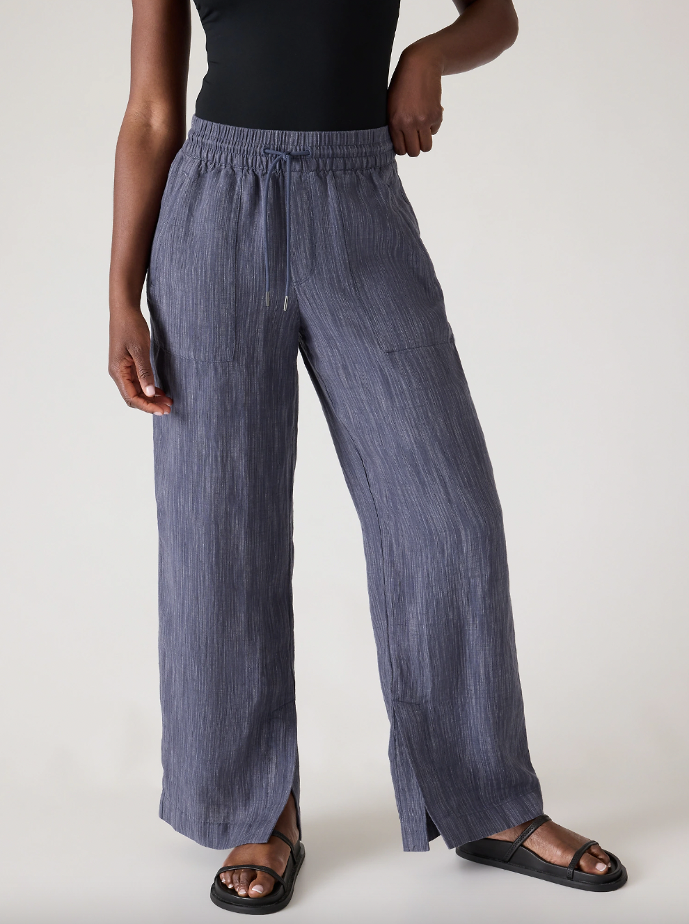 Waist-down image of Athleta model wearing violet linen pants