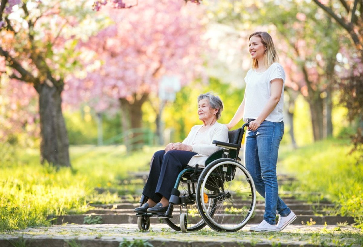 woman pushing mother in wheelchair, how parenting has changed