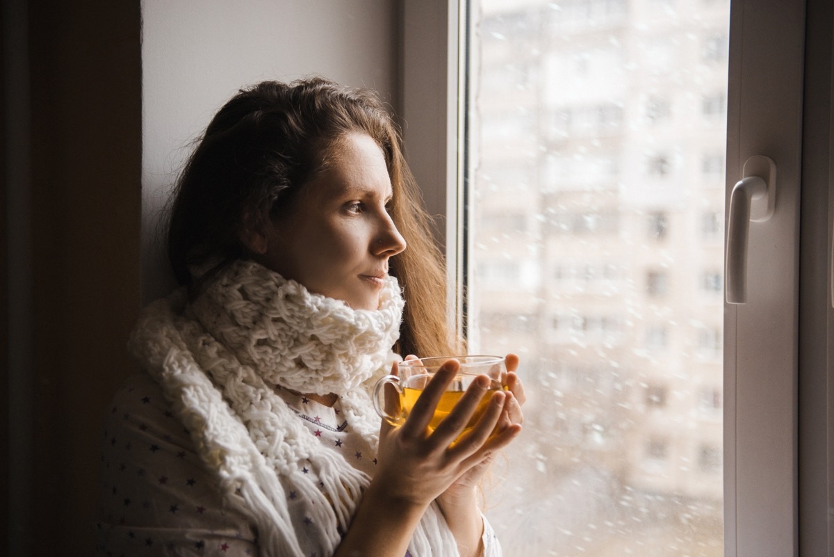 cold woman drinking a cup of tea