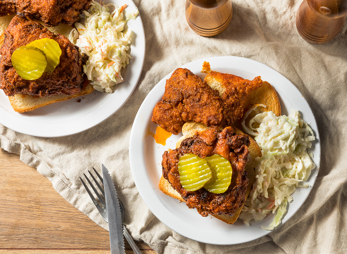 homemade plates of nashville hot chicken with pickles