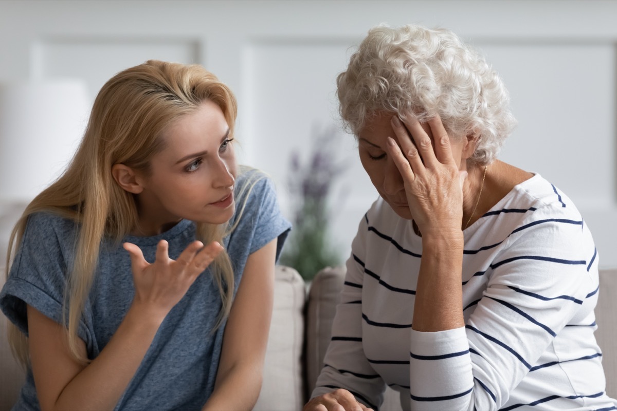 Family sit on couch having dispute, grown up daughter proves her right aggressively argue with elderly mother, 60s mom in despair due to misunderstanding. Generational gap, conflicts at home concept