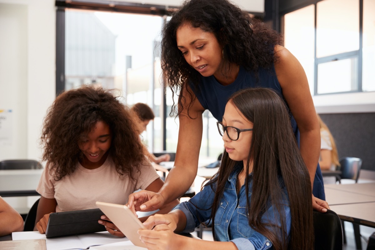 middle age woman mentoring teenagers