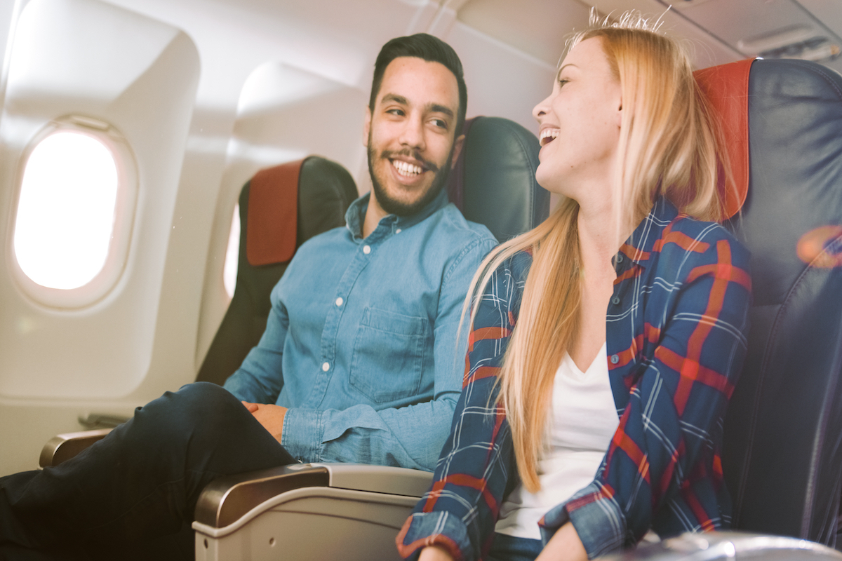 A couple talking loud on an airplane.