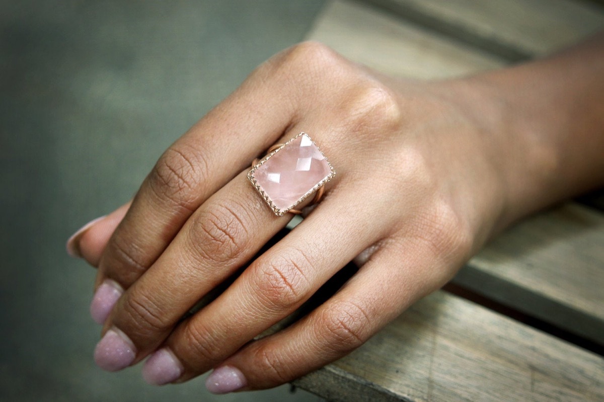 woman's hand with pink nail polish and large rectangular pink stone, Etsy jewelry