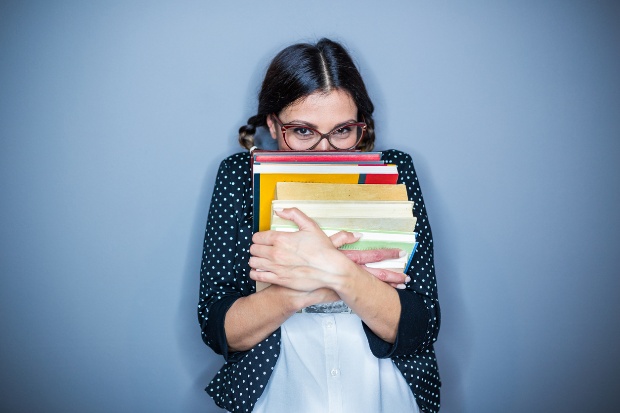 Nerd girl holding some books