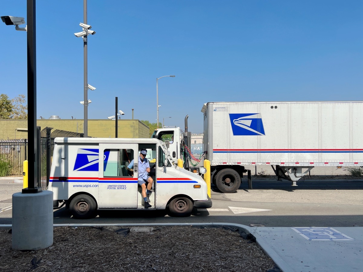 Los Angeles, California, USA - August 27, 2022: USPS delivery truck departure from USPS Annex at Los Angeles Downtown.