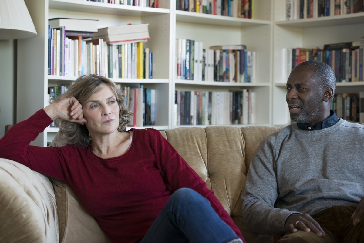 Mature Couple in disagreement on a couch in their lounge.