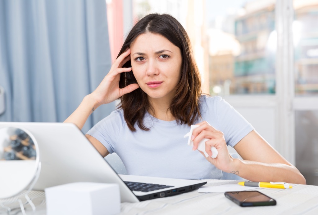 Woman is at work at her laptop and is offended by what someone said.