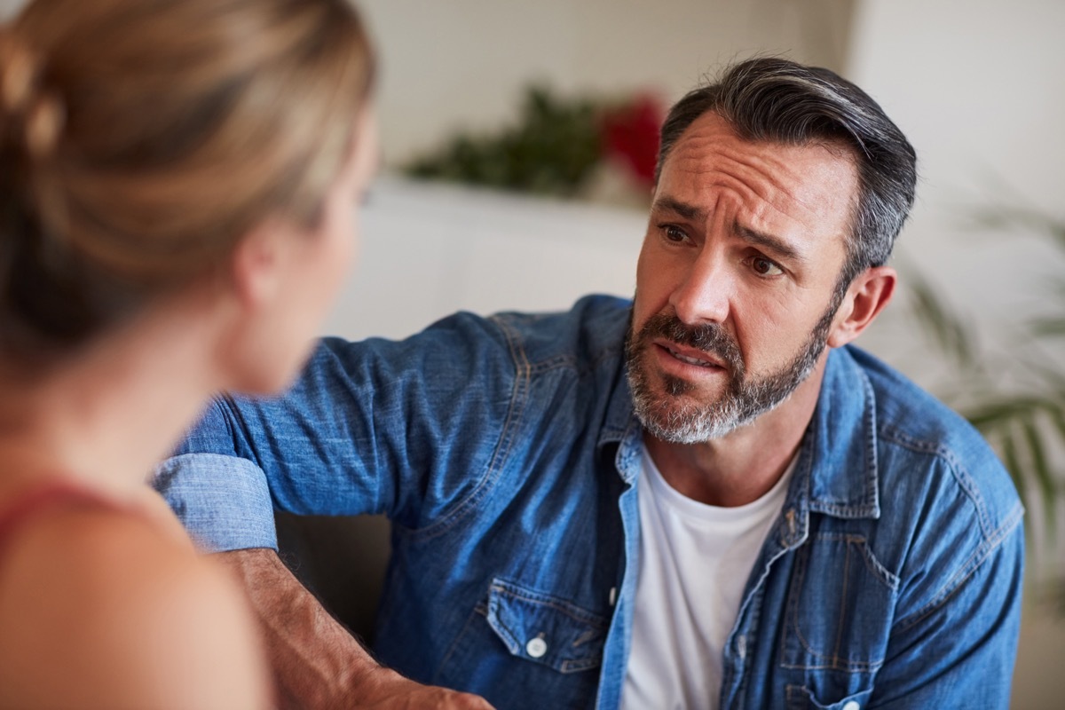 man looking concerned while talking to the woman across from him